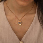 Rose Gold pendant necklace featuring an engraved portrait of a cat worn by a woman