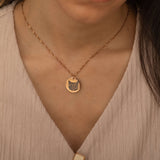 Rose Gold pendant necklace featuring an engraved portrait of a cat worn by a woman