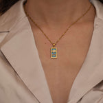 Gold the sun tarot necklace with cubic zirconia accents and an turquoise  back stone, symbolizing happiness, vitality, and success. 