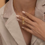 Gold the wheel tarot necklace with cubic zirconia accents and a mother of pearl back stone, symbolizing change, destiny, and the cycles of life. 