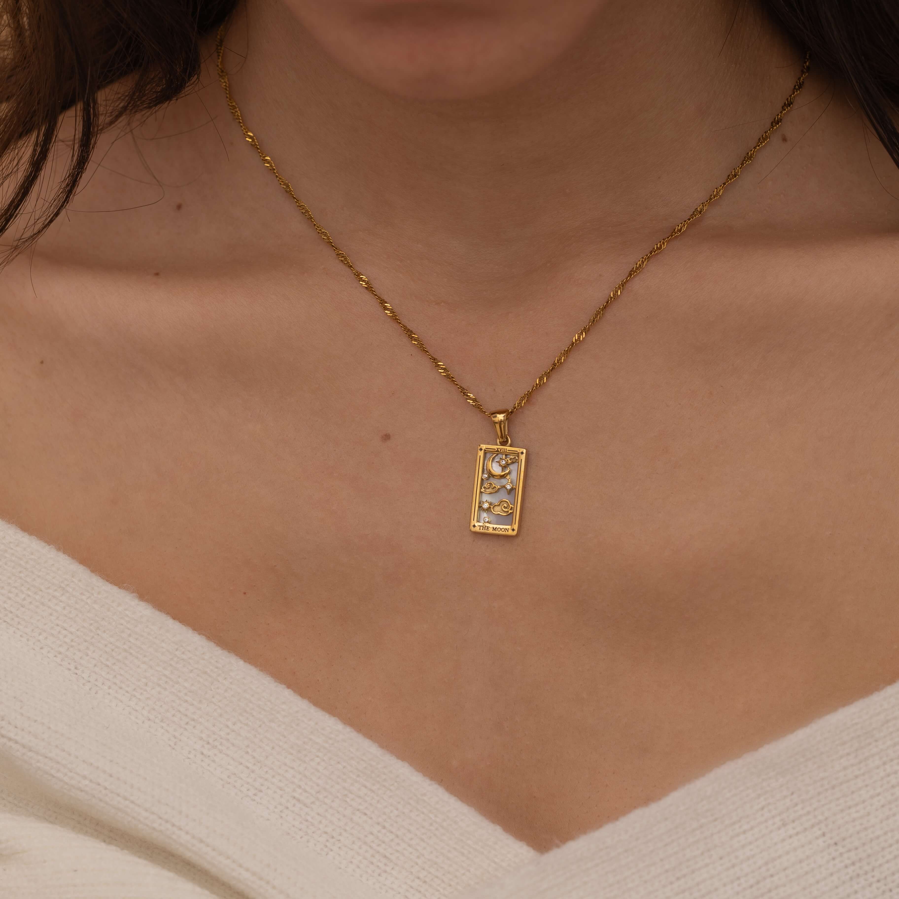 Gold The Moon tarot necklace with cubic zirconia accents and an mother of pearls back stone, symbolizing intuition, mystery and subconscious. 