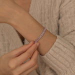 Elegant silver tennis bracelet featuring shimmering pink stones, ideal for both casual and formal occasions.