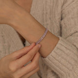 Elegant silver tennis bracelet featuring shimmering pink stones, ideal for both casual and formal occasions.