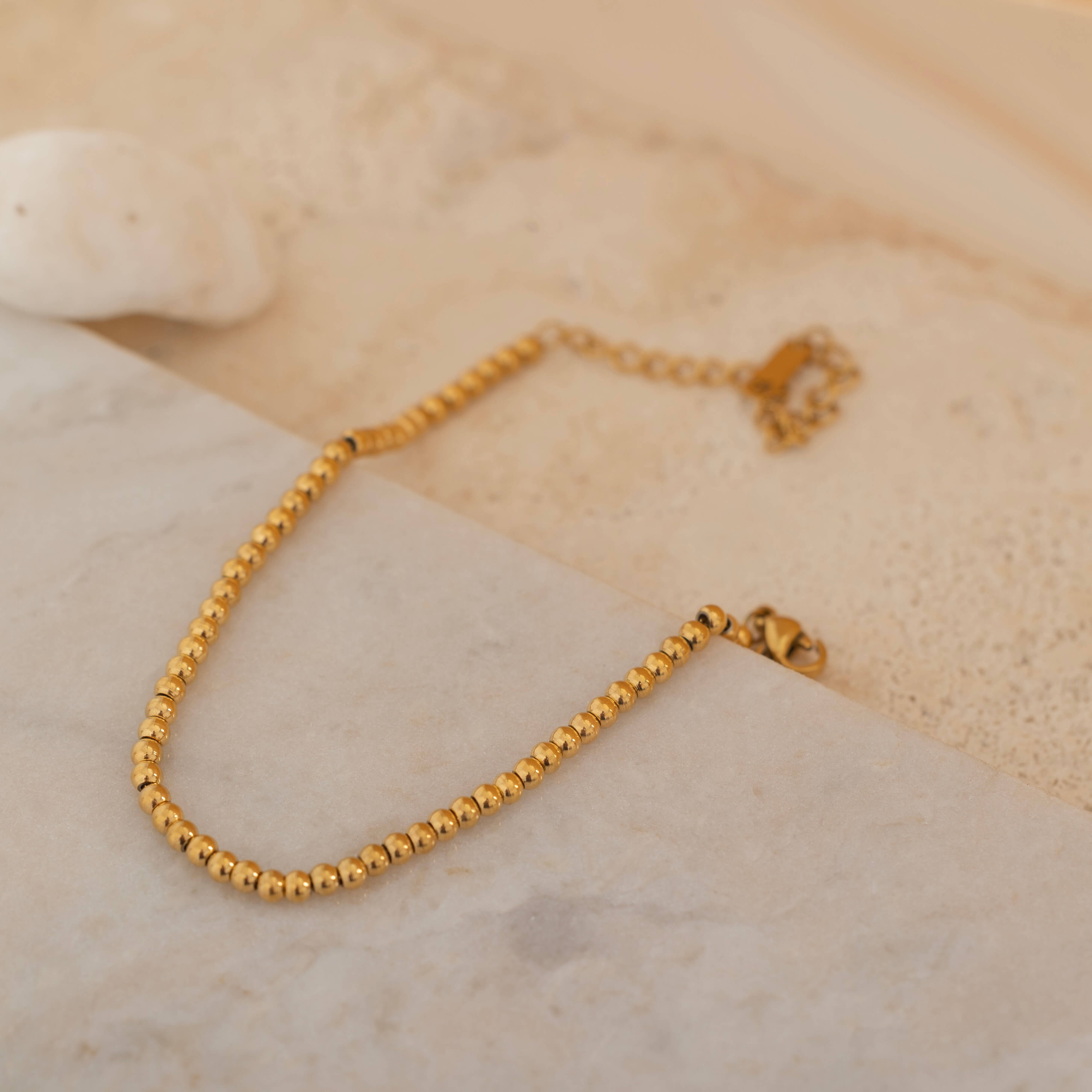 Gold beaded bracelet featuring sleek, polished beads, designed to be tarnish-free and waterproof, ideal for both casual and formal wear