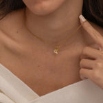 Gold Custom Sunburst Initial Necklace with custom birthstones. Perfect for everyday wear, waterproof and tarnish free