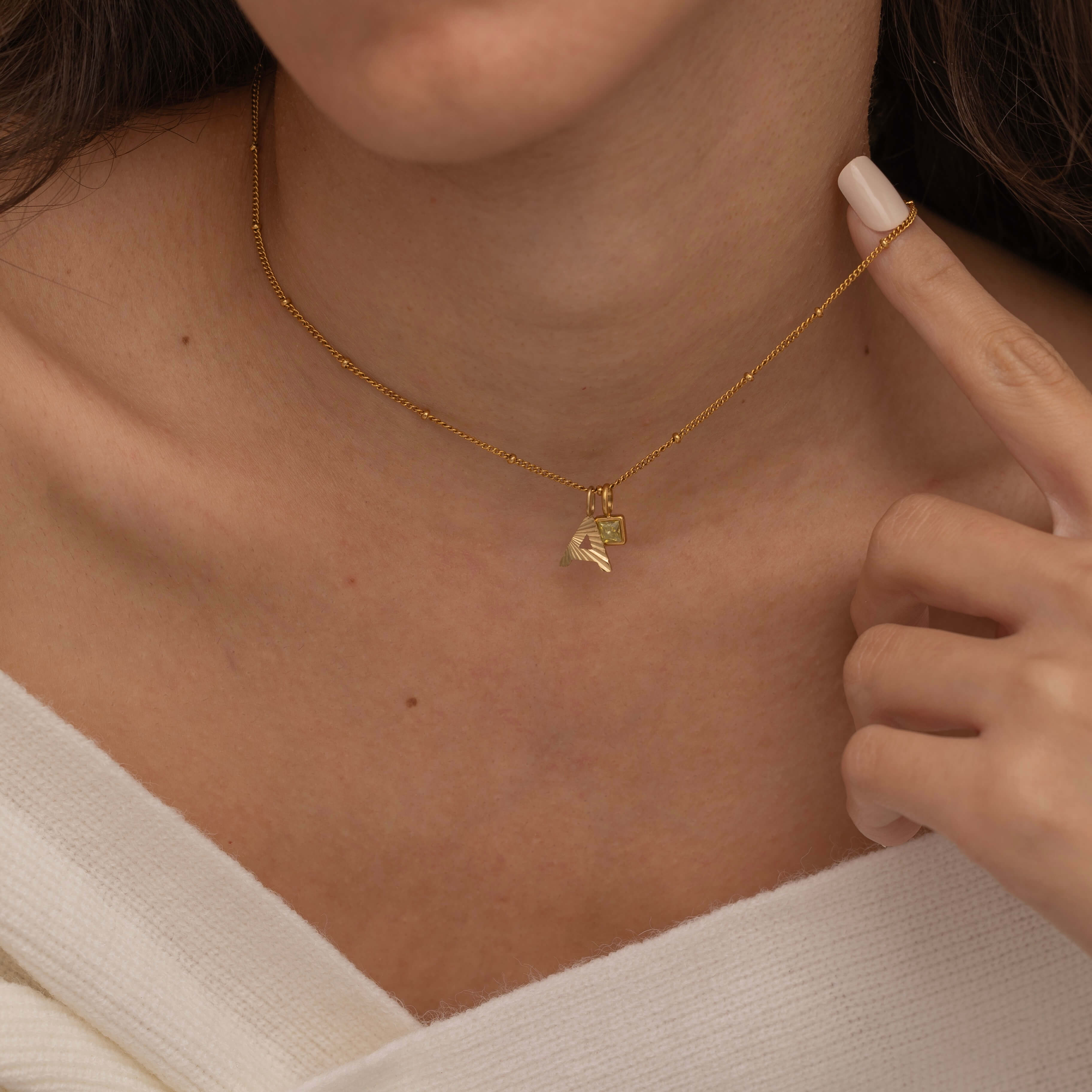 Gold Custom Sunburst Initial Necklace with custom birthstones. Perfect for everyday wear, waterproof and tarnish free