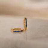 gold blue sapphire huggie hoop earrings 