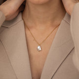 A stunning Baroque Pearl Necklace with a unique, irregularly shaped pearl pendant on a delicate gold chain, perfect for adding a touch of elegance to any outfit.