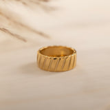 Elegant gold ring with a bold, ridged texture