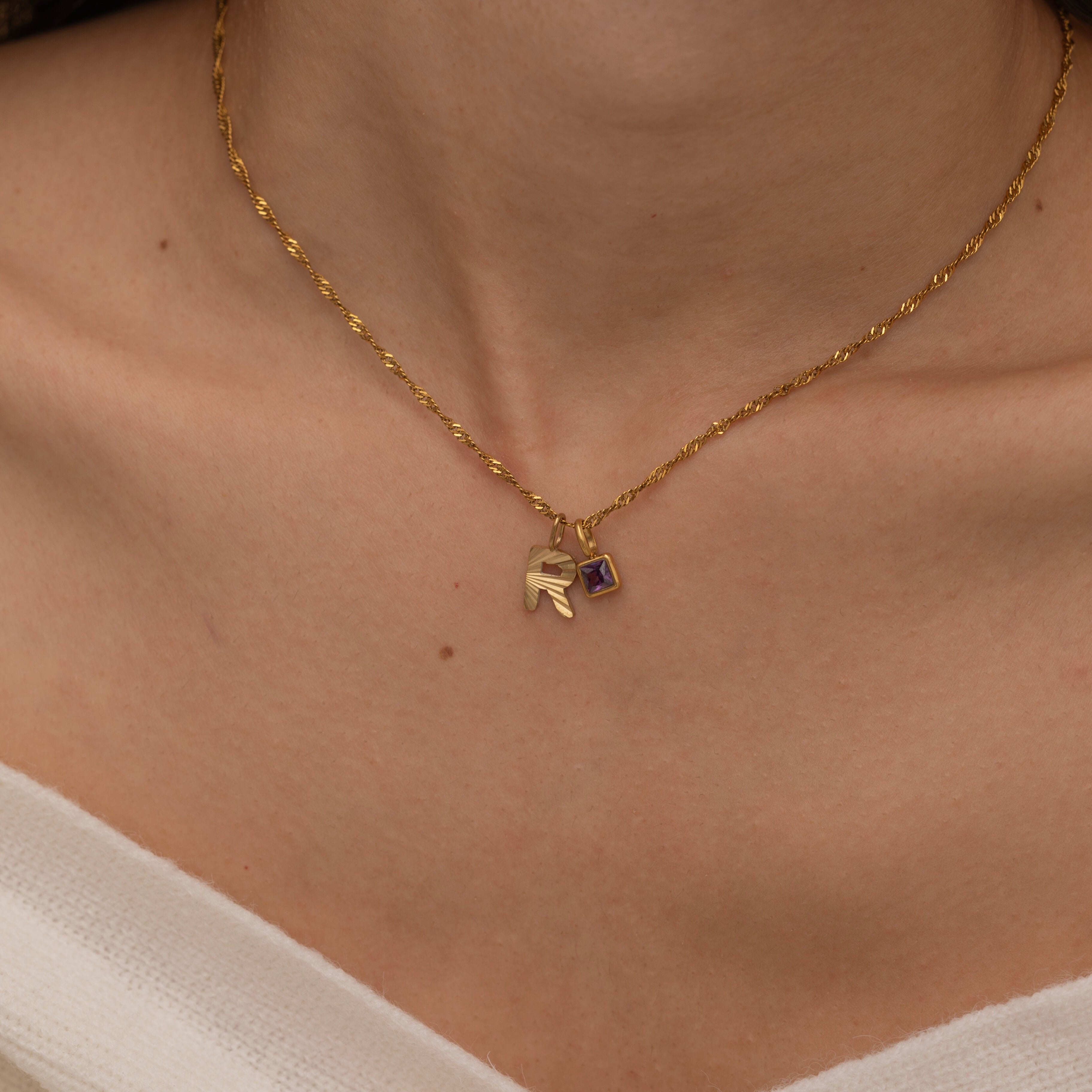 Gold Custom Sunburst Initial Necklace with custom birthstones. Perfect for everyday wear, waterproof and tarnish free