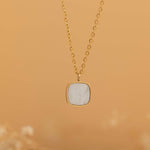 Square mother of pearl pendant with a gold frame on a gold chain