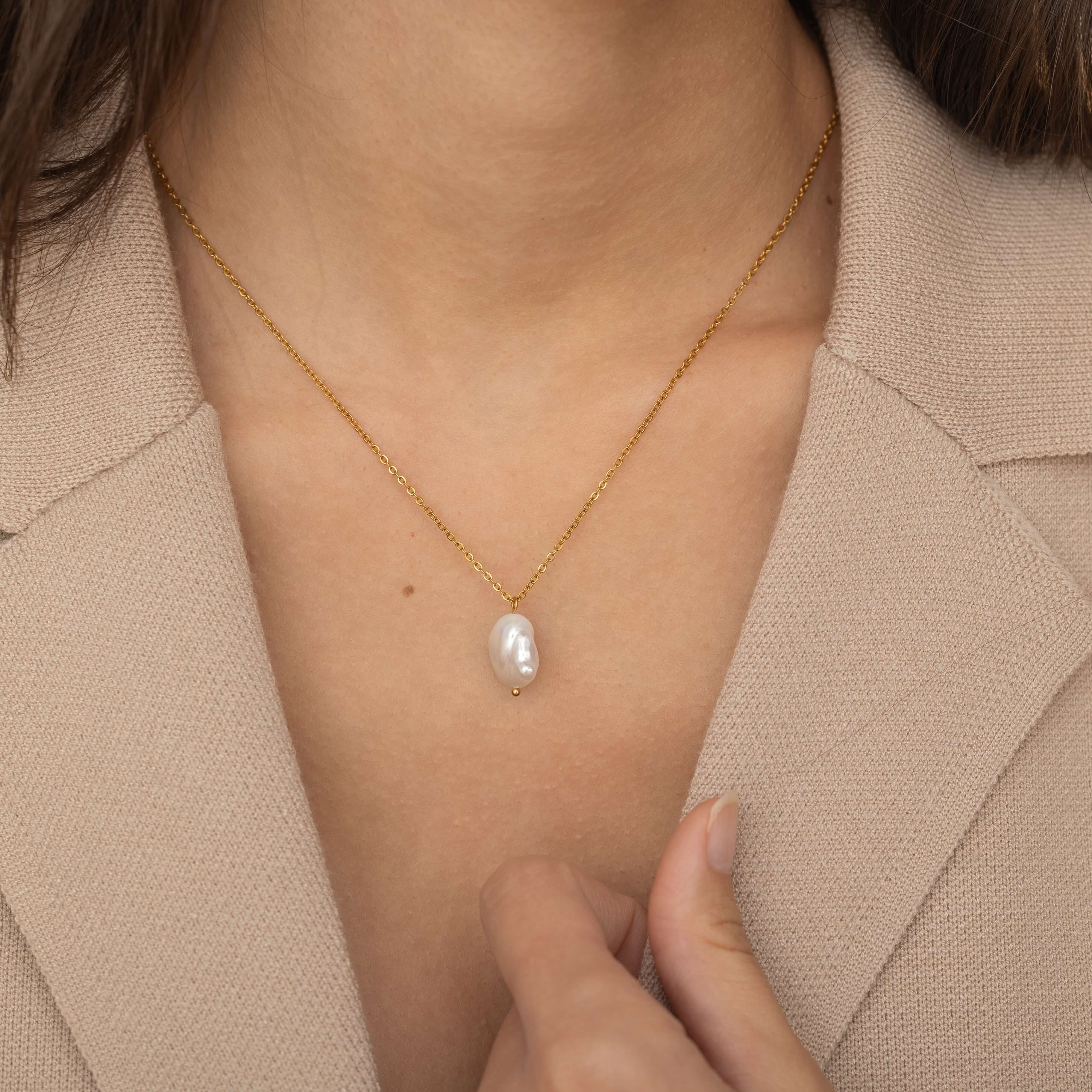 Baroque Pearl Necklace showcasing its beautiful, natural imperfections and sophisticated gold chain, ideal for special occasions or everyday wear.