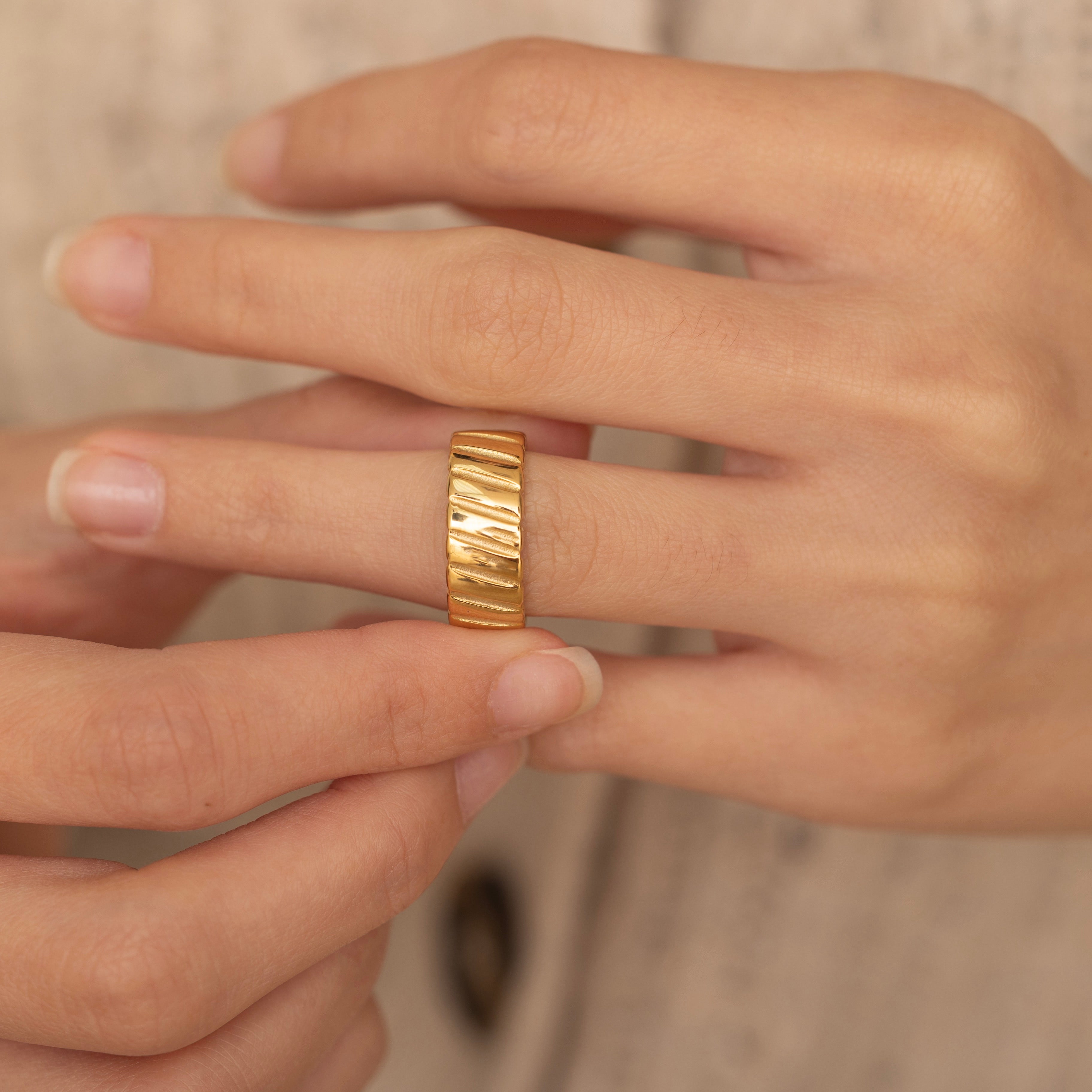 Modern gold ring featuring a unique ridged pattern