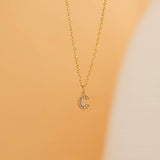 Gold initial pendant necklaces with crystal-studded alphabet charms on custom gold chains