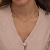 Gold initial pendant necklaces with crystal-studded alphabet charms on custom gold chains