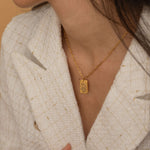 Gold zodiac pendant necklace with engraved zodiac symbol