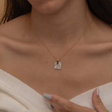 Square mother of pearl pendant with a soft iridescent finish, showcasing natural color variations and a minimalist design.