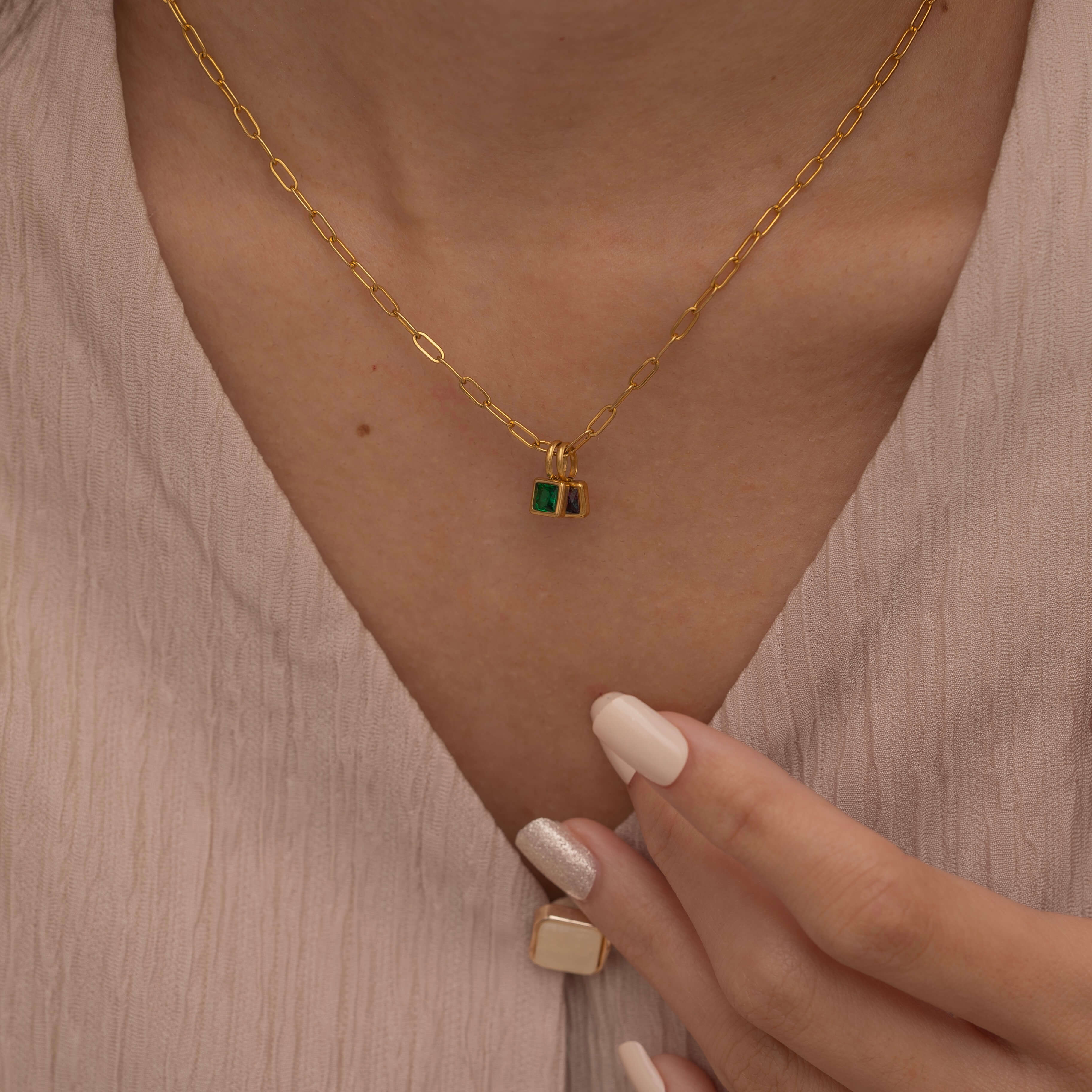 Square birthstone charms in gold and silver frames on a necklace, with multiple colorful birthstone charms representing different birth months