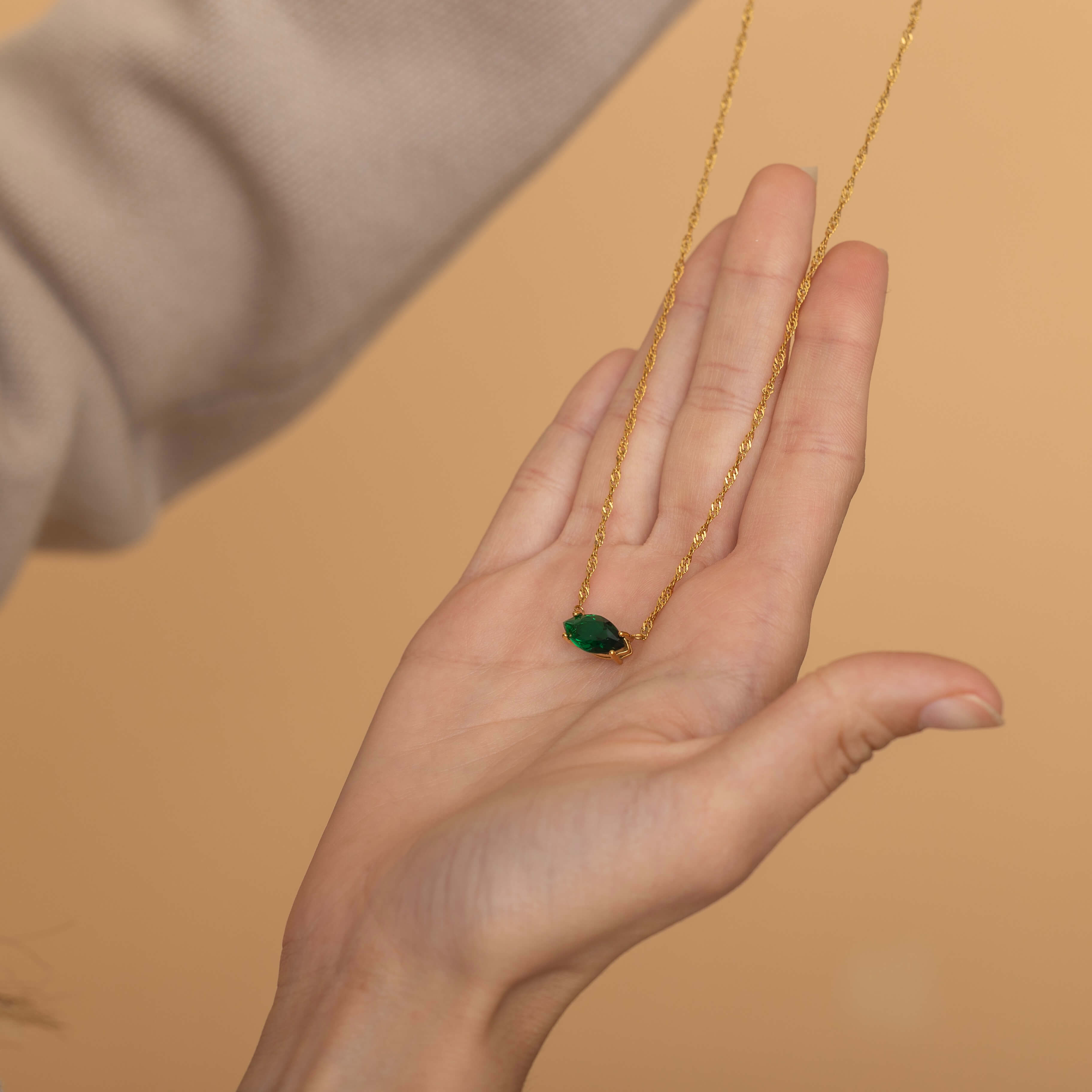 Marquise Diamond Emerald Necklace with a twisted singapore chain.