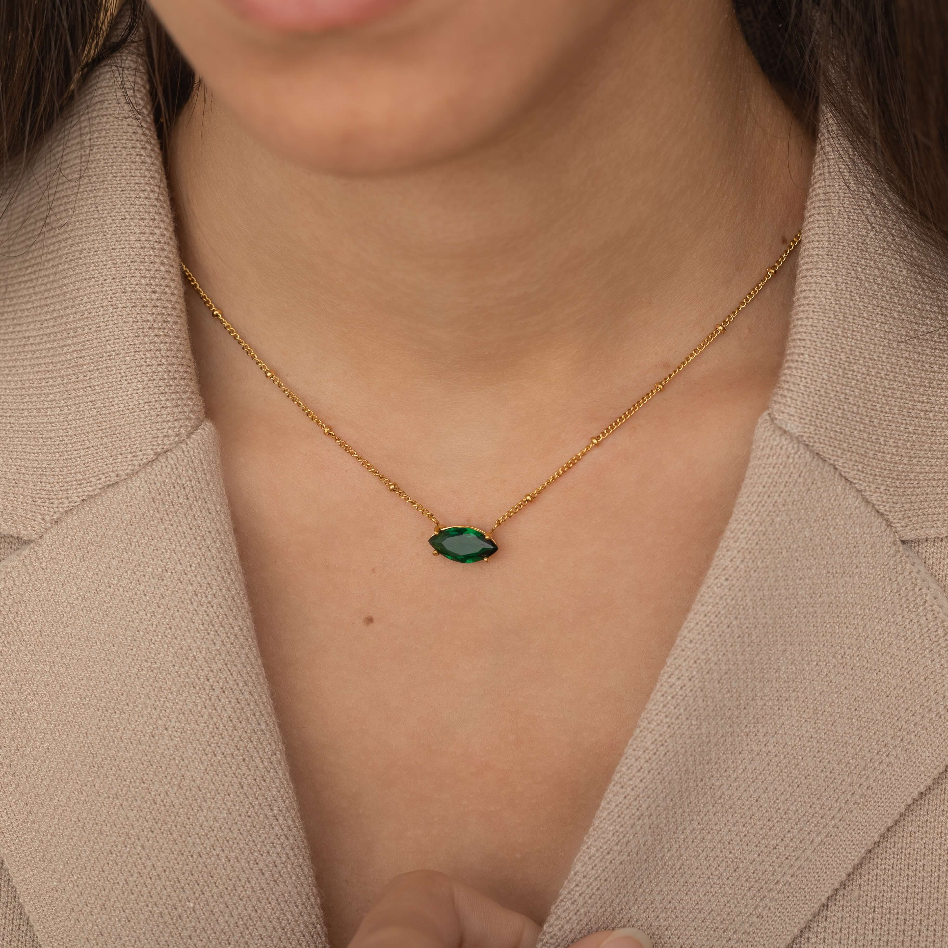 large marquise emerald green stone necklace with satellite chain.