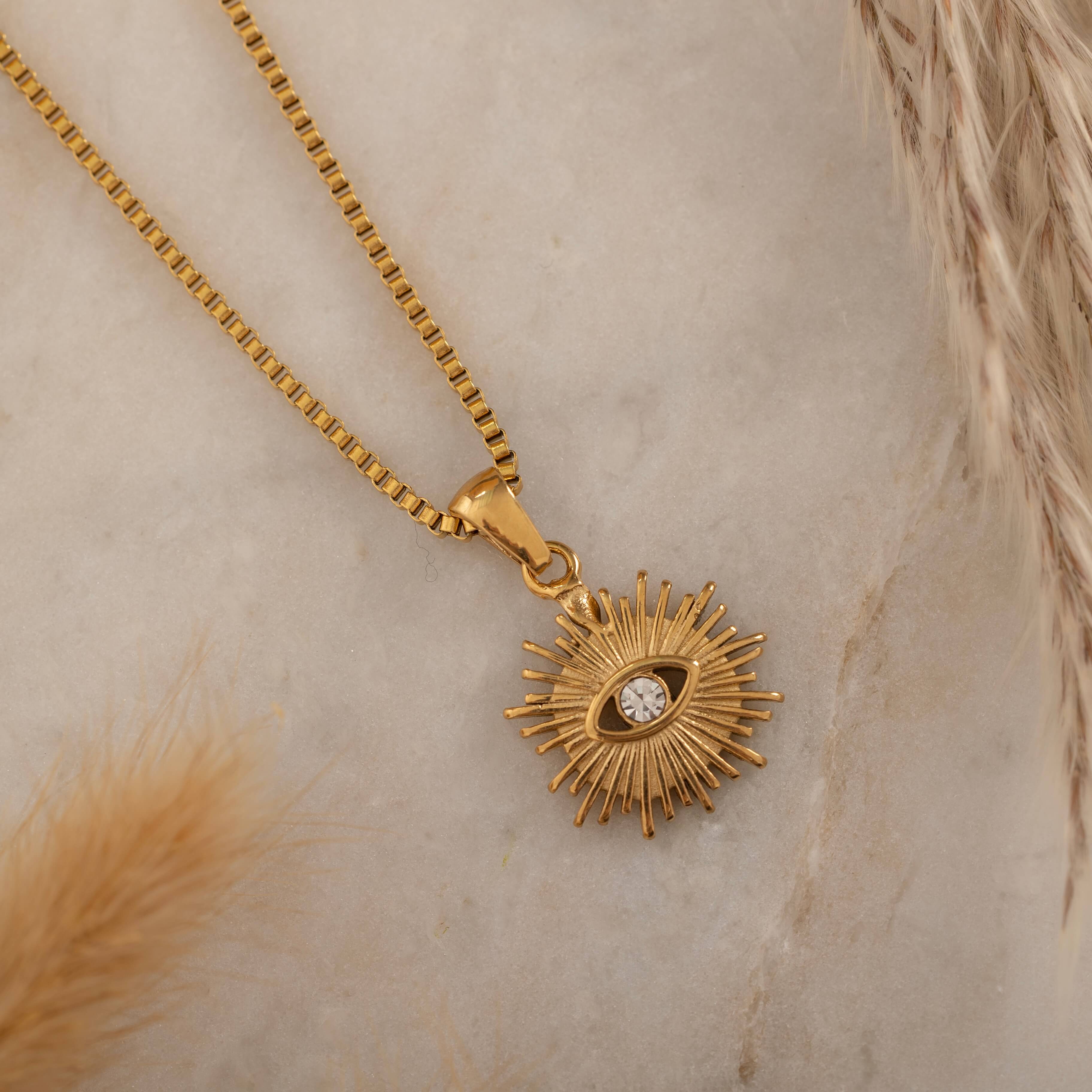 Elegant gold necklace with a radiant sunburst pendant