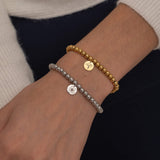 Gold and silver birth flower bead bracelets with engraved flower charms