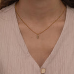 Gold initial pendant necklaces with crystal-studded alphabet charms on custom gold chains