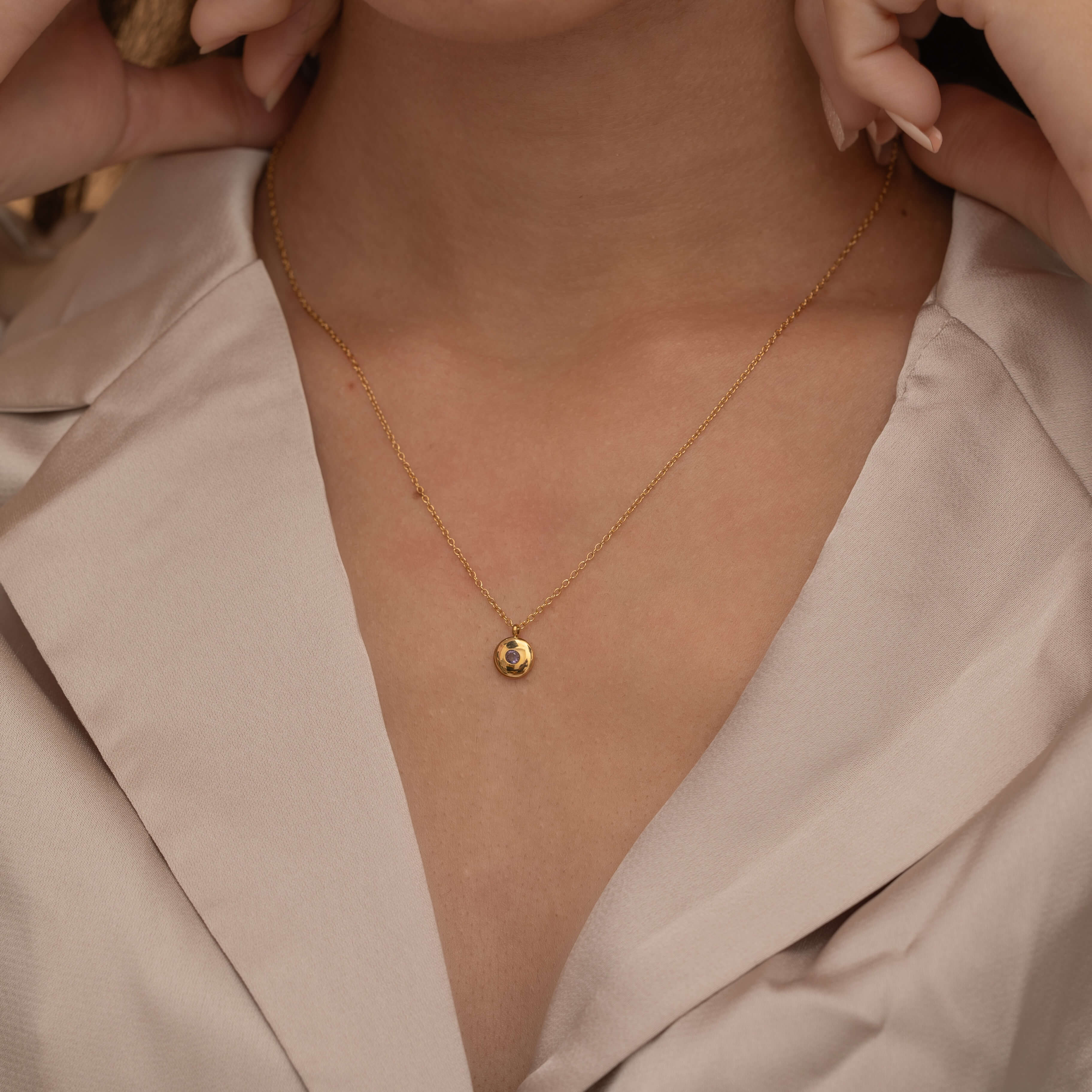 Round birthstone necklace with a polished coin pendant and center-set birthstone, offering personalized elegance and meaning for each birth month