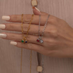 Square birthstone charms in gold and silver frames on a necklace, with multiple colorful birthstone charms representing different birth months