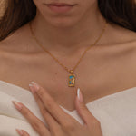 Gold the empress tarot necklace with cubic zirconia accents and an turquoise back stone, symbolizing abundance, beauty, and feminine power. 