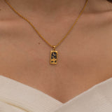 Gold  the knight of cups tarot necklace with cubic zirconia accents and a black onyx back stone, symbolizing emotional depth, intuition, and the pursuit of dreams