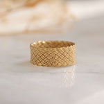 Intricate gold woven design ring with elegant texture