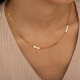 Gold necklace with multiple engraved name bar charms, personalized family name jewelry