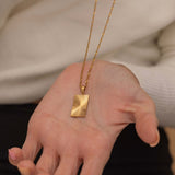 rectangle sunburst necklace with an etched sunburst design on a rectangle pendant, symbolizing warmth and vitality, perfect for adding a touch of boho elegance.