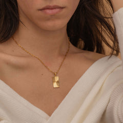 rectangle sunburst necklace with an etched sunburst design on a rectangle pendant, symbolizing warmth and vitality, perfect for adding a touch of boho elegance.