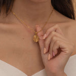 Circle sunburst necklace with an etched sunburst design on a round pendant, symbolizing warmth and vitality, perfect for adding a touch of boho elegance.