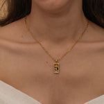 Gold Temperance tarot necklace with cubic zirconia accents and an onyx back stone, symbolizing balance and harmony.