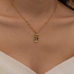 Gold Temperance tarot necklace with cubic zirconia accents and an onyx back stone, symbolizing balance and harmony.