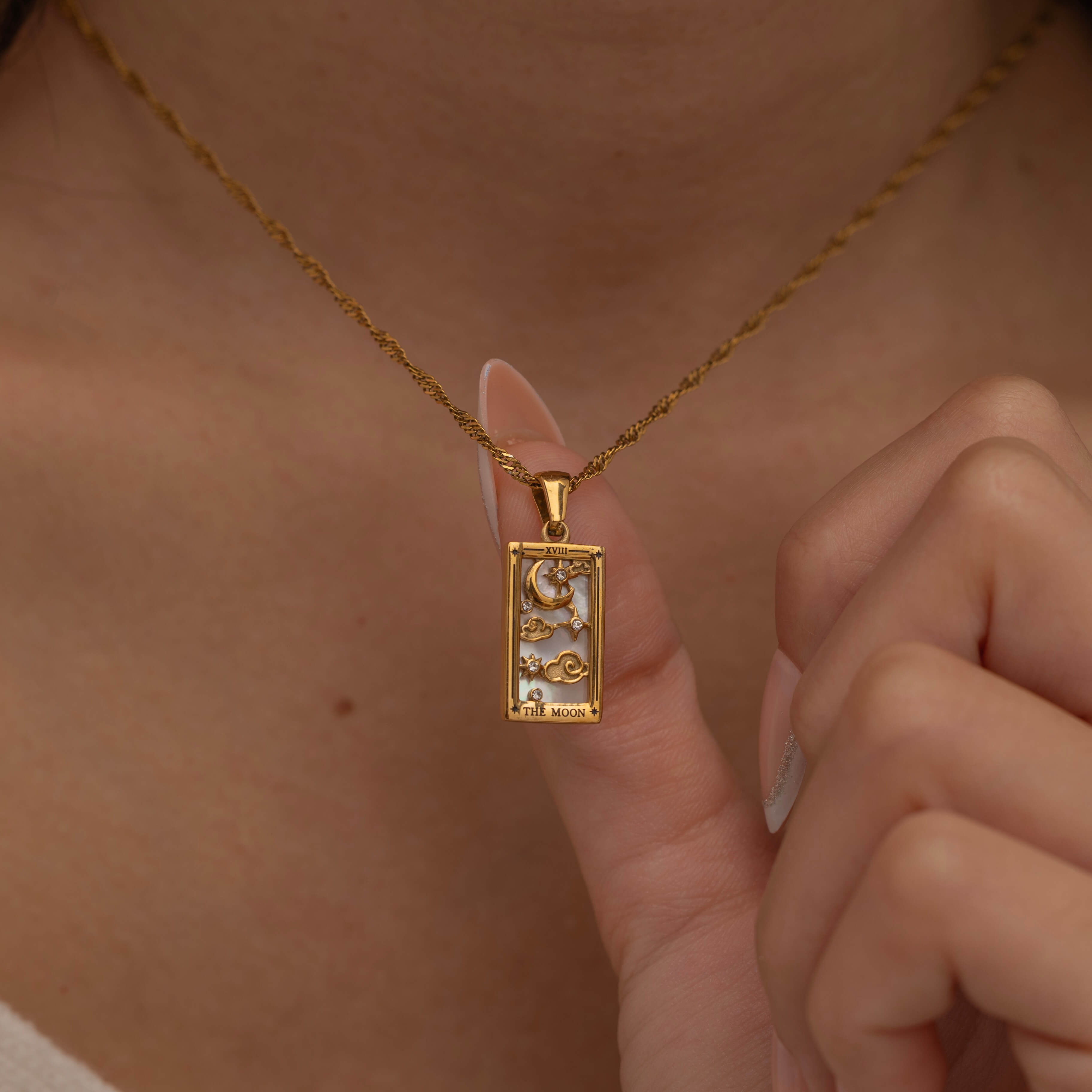 Gold The Moon tarot necklace with cubic zirconia accents and an mother of pearls back stone, symbolizing intuition, mystery and subconscious. 