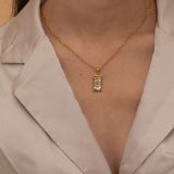 Gold the wheel tarot necklace with cubic zirconia accents and a mother of pearl back stone, symbolizing change, destiny, and the cycles of life. 