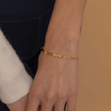 Gold multi-name bar bracelet with customizable engraved bars showcasing its elegant and personalized design.