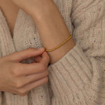 Tarnish-free and waterproof gold beaded bracelet with polished beads, perfect for adding a touch of elegance to any outfit