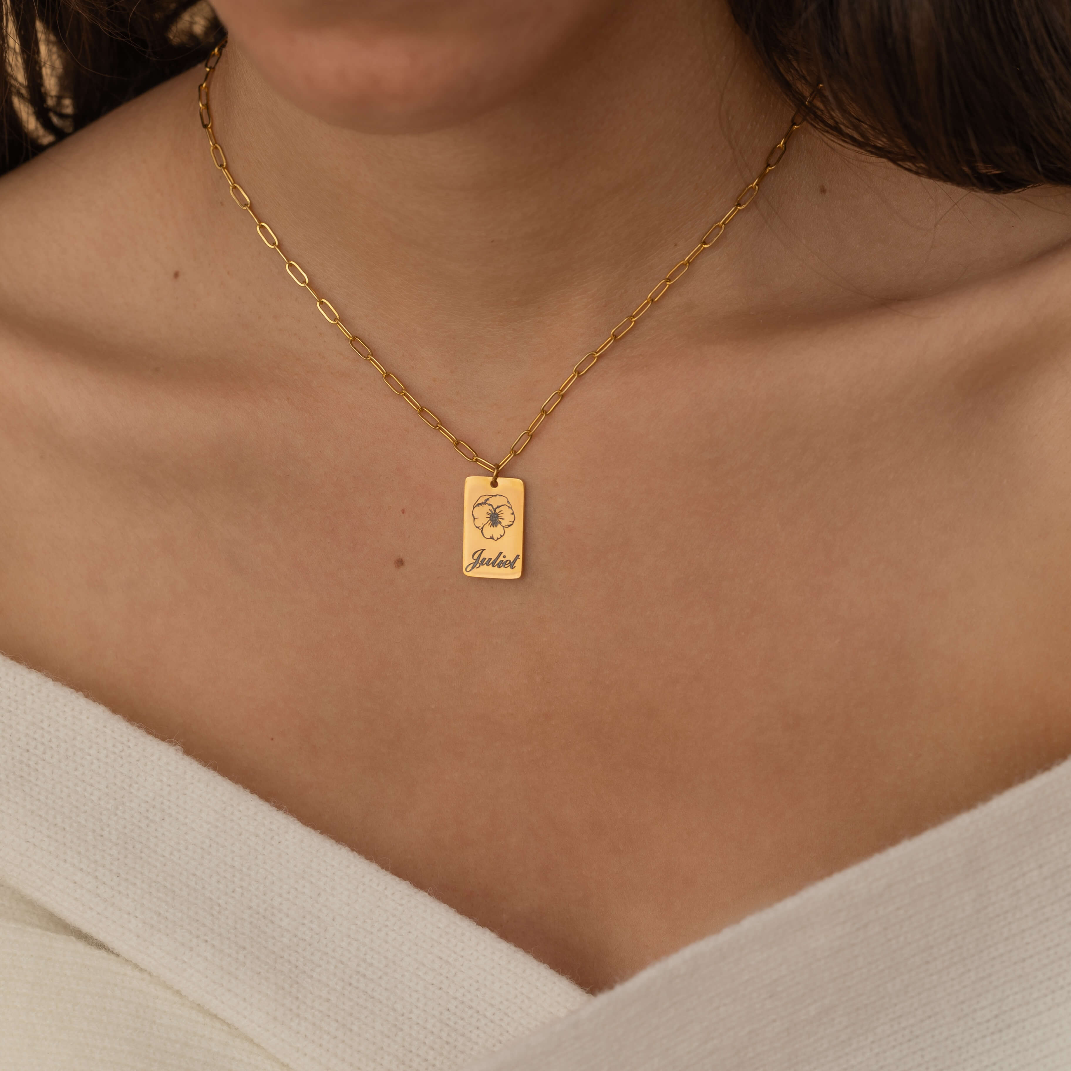 Gold necklace with engraved birth flower and name pendant, featuring a customizable birth month jewelry.