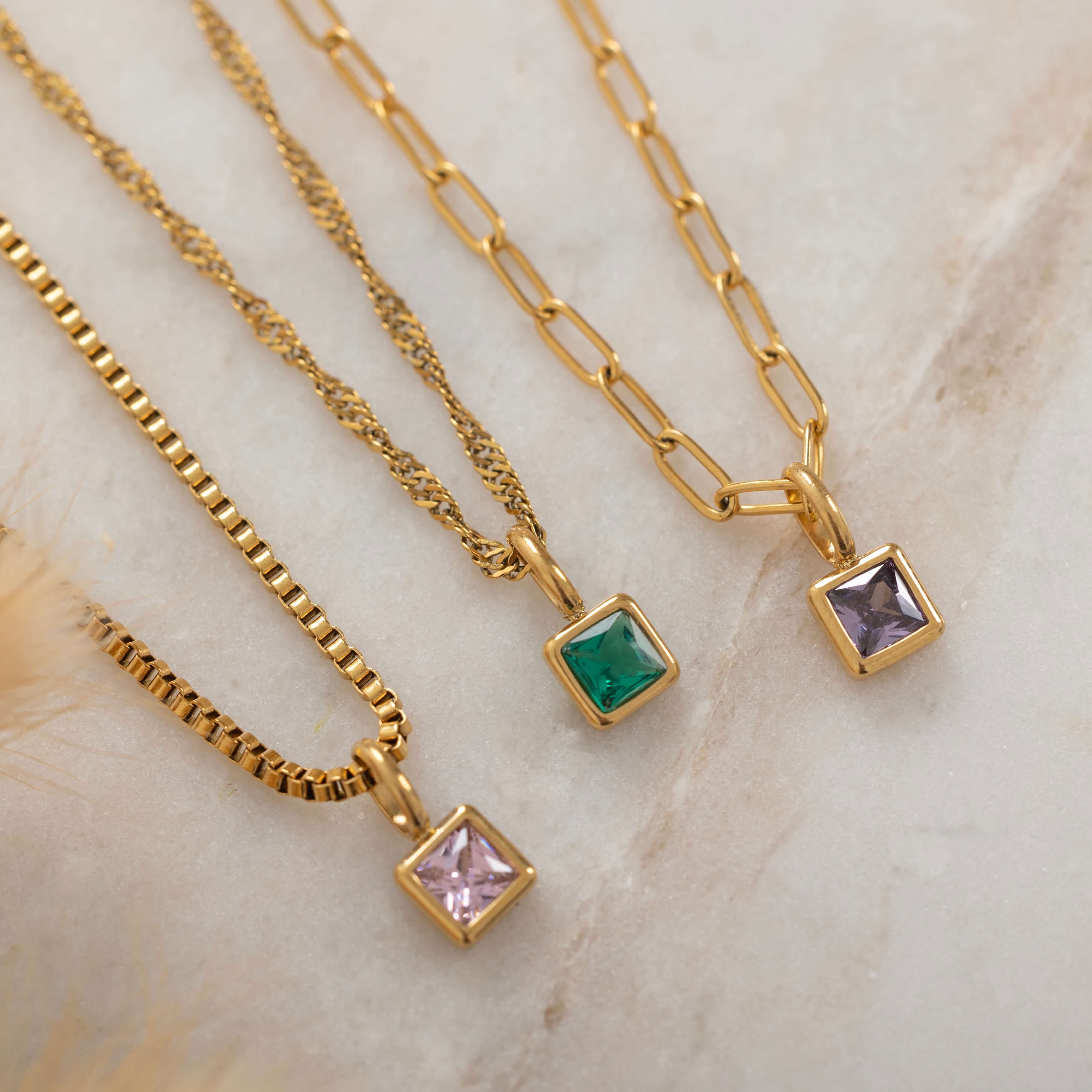 Square birthstone charms in gold and silver frames on a necklace, with multiple colorful birthstone charms representing different birth months