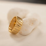 Stylish wide-band gold ring with a polished finish