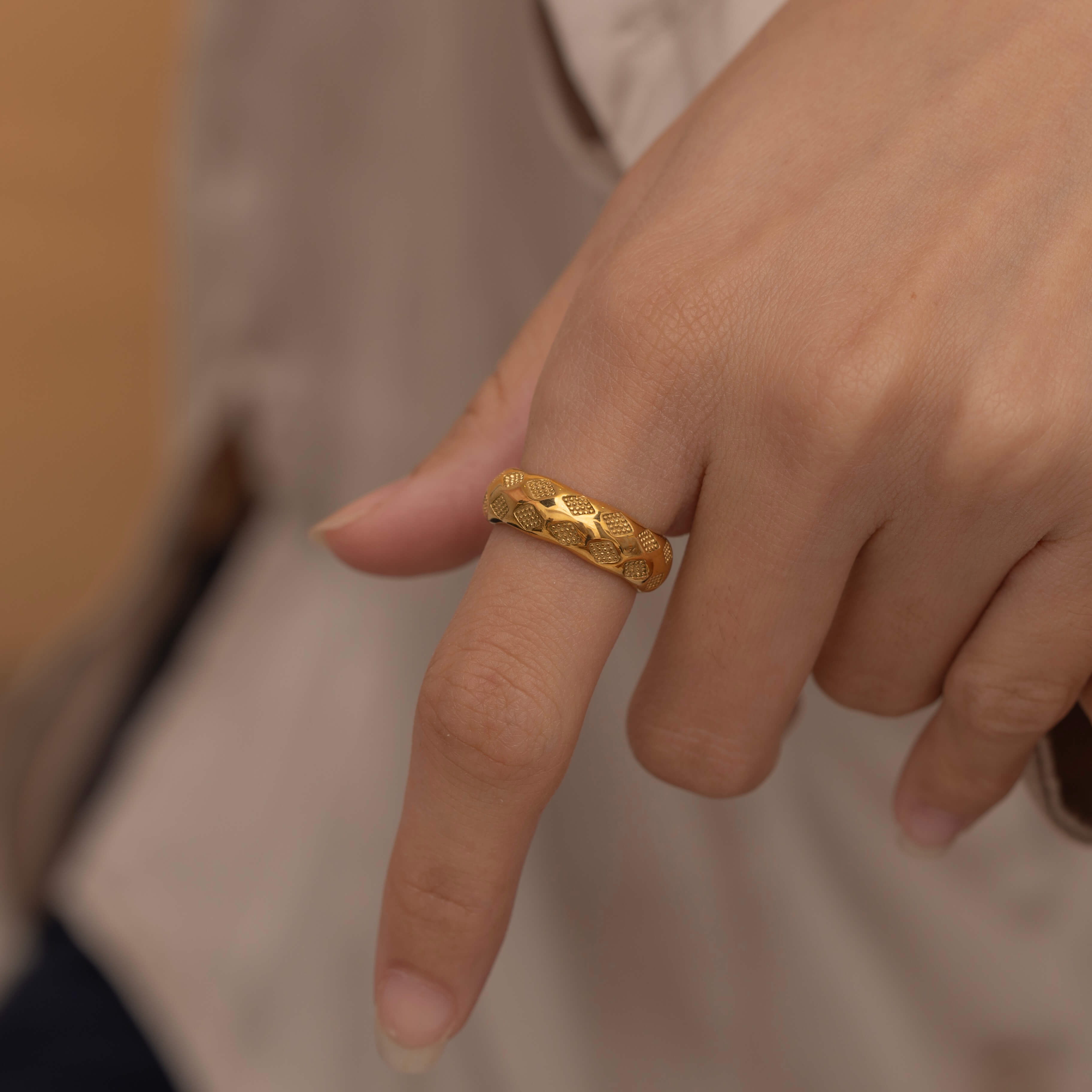 Gold checkered ring with textured design, stylish and modern statement jewelry piece