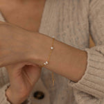 a delicate gold bracelet with elegant pearls