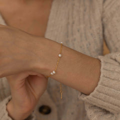 a delicate gold bracelet with elegant pearls