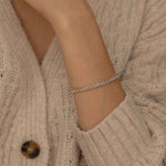 Gold and silver tennis bracelets with dazzling stones highlighting their elegant and classic design