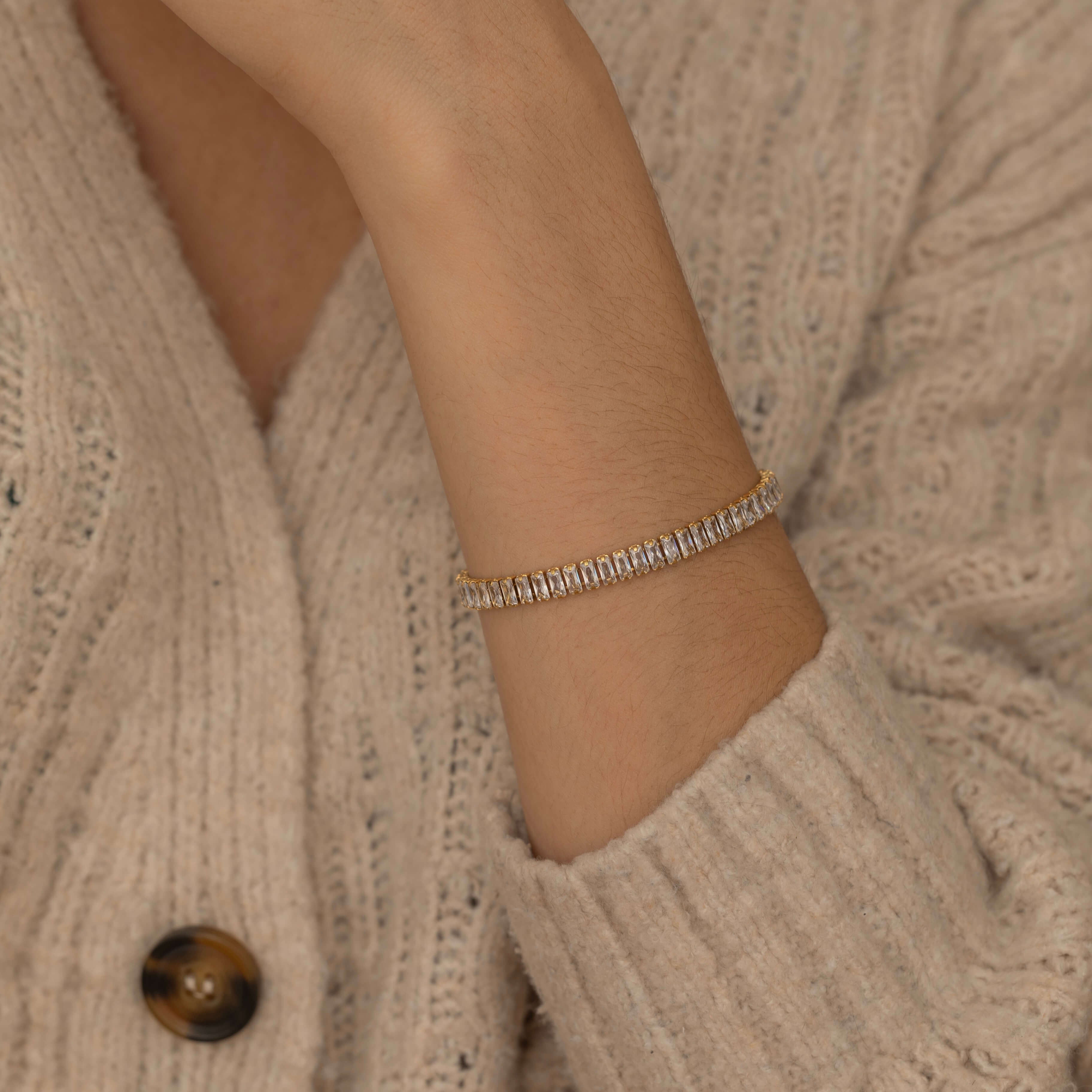 Gold and silver tennis bracelets with dazzling stones highlighting their elegant and classic design